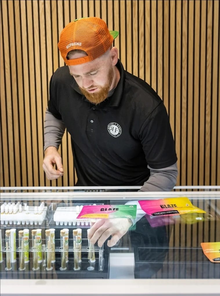 ReMaine Humble Farms budtender helping a patient
